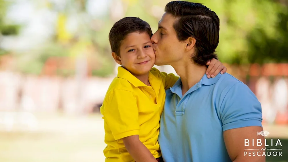 Father kissing son on cheek