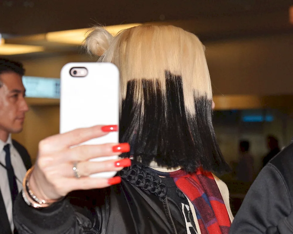 Faded blonde roots on dark hair