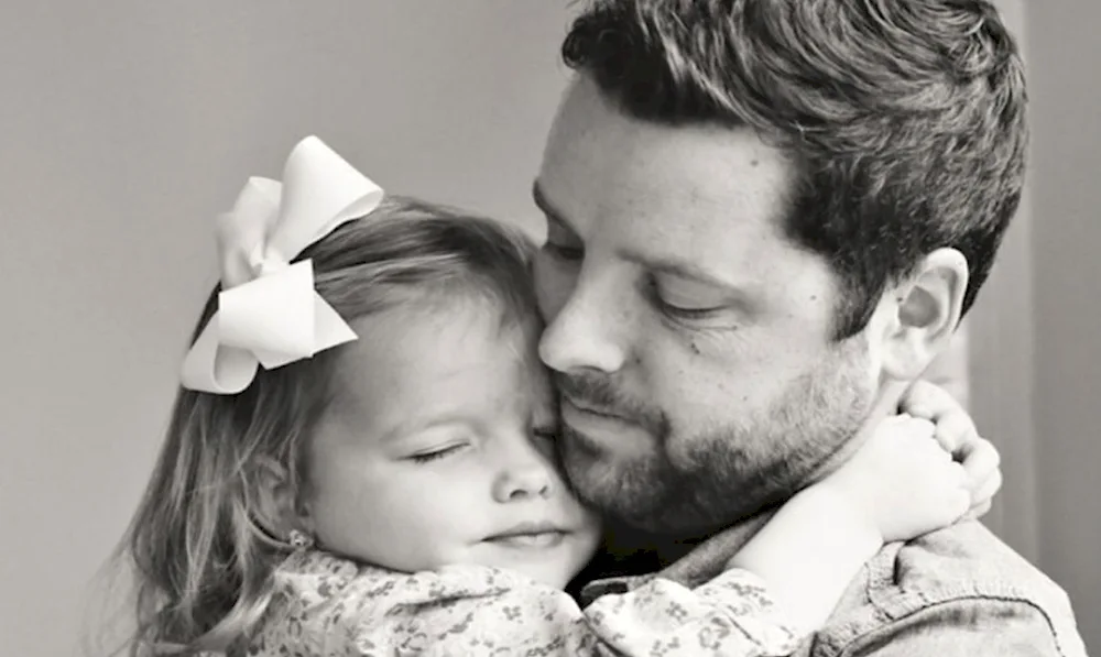 Dad hugs daughter