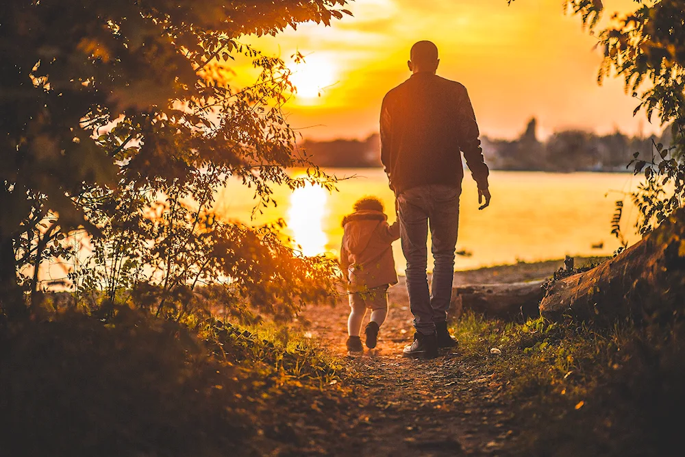 Dad and daughter at sunset