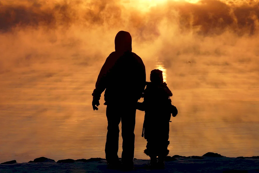 Dad and son at sunset