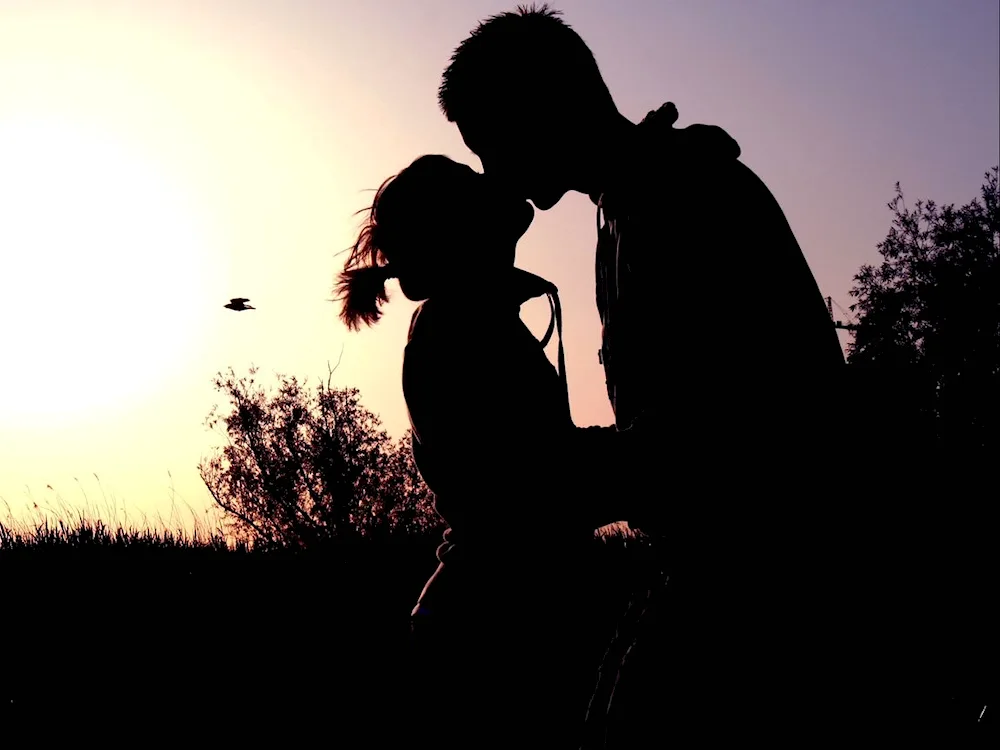 Boy and girl kissing in the dark