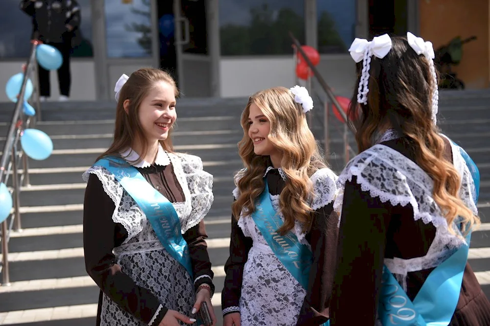 Beautiful graduates in school uniform