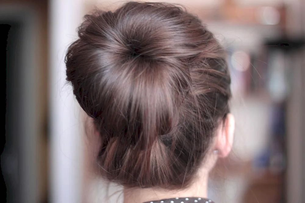 Babetta. bouffant bun on the back of the head