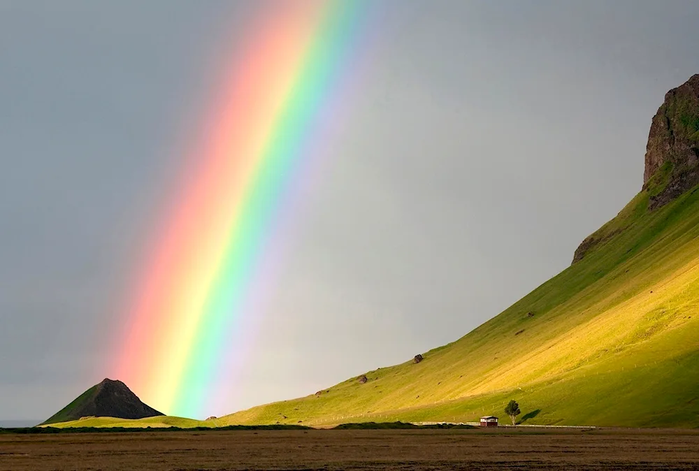 Sun and mountain rainbow