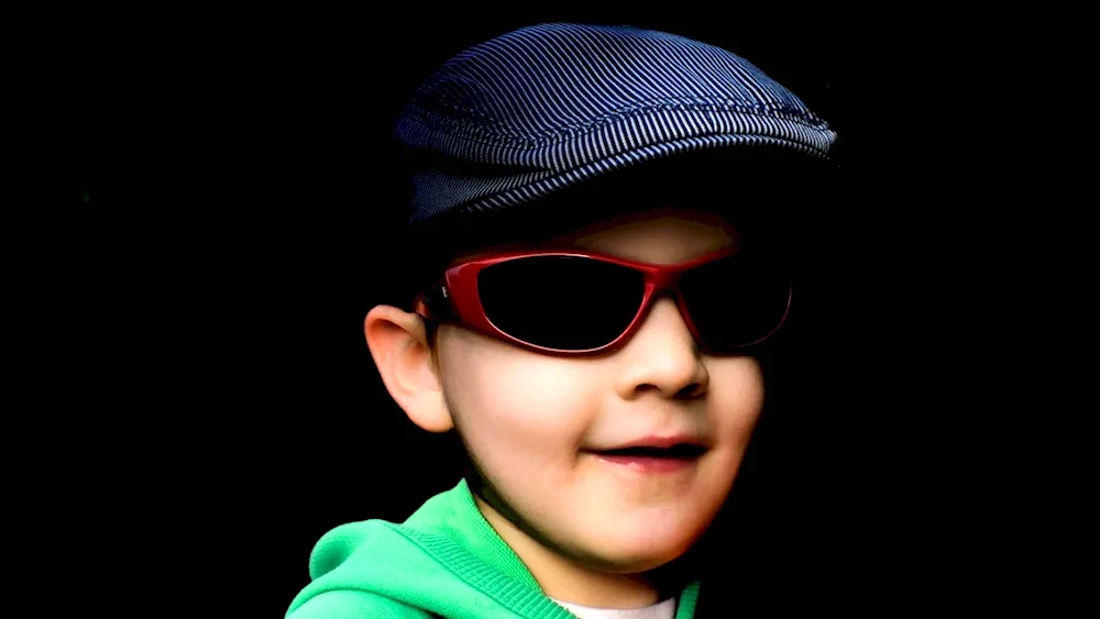 Child with dark glasses