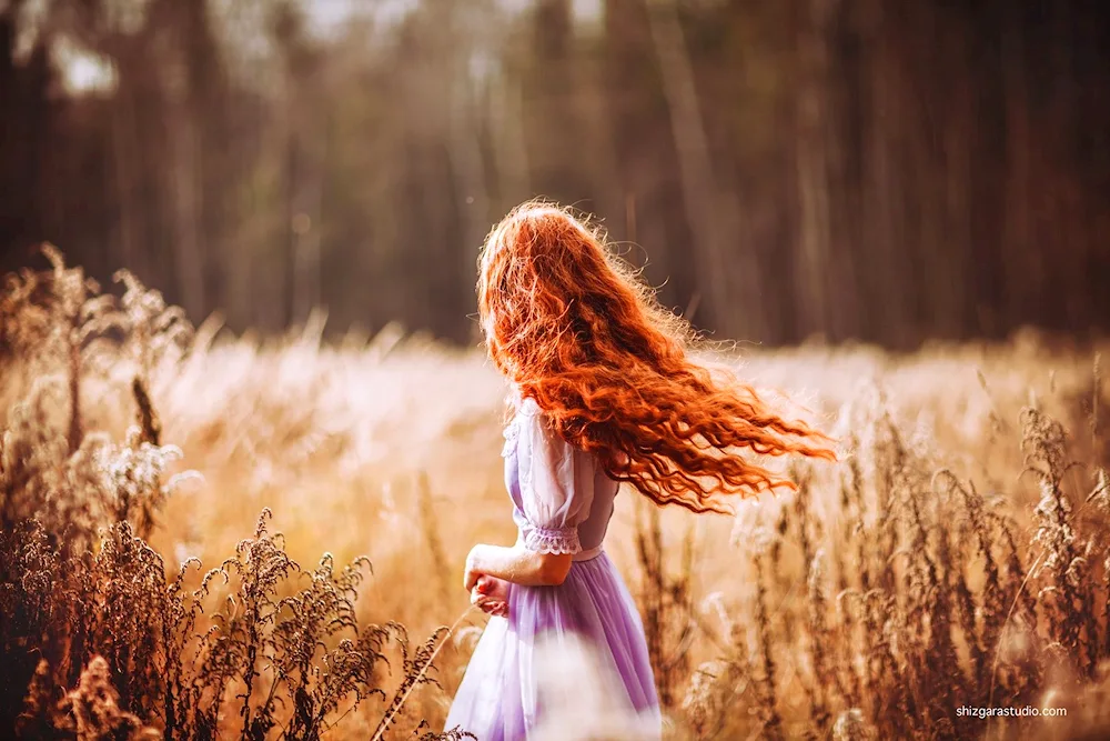 Red girl with brown hair from back