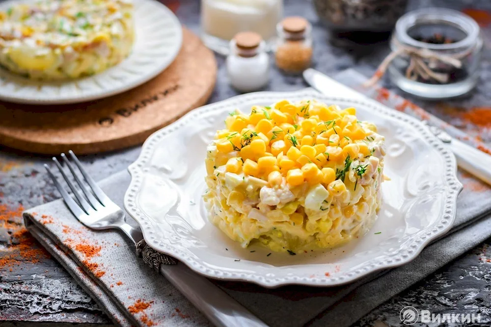 Salad with pineapple and smoked chicken and corn and cheese stuffed pineapple baked