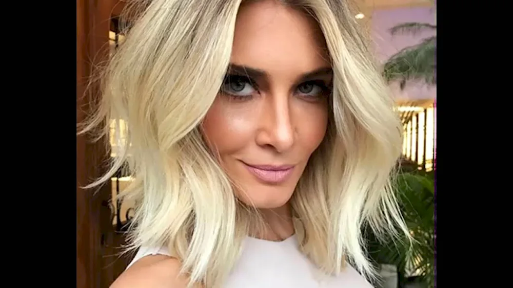 Short blonde haircut with dark roots