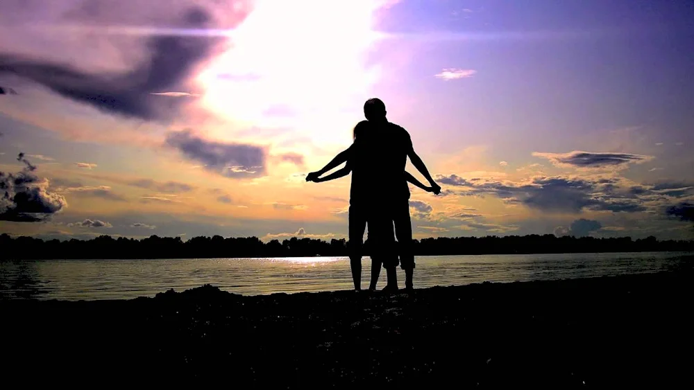 Silhouettes of lovers at sunset