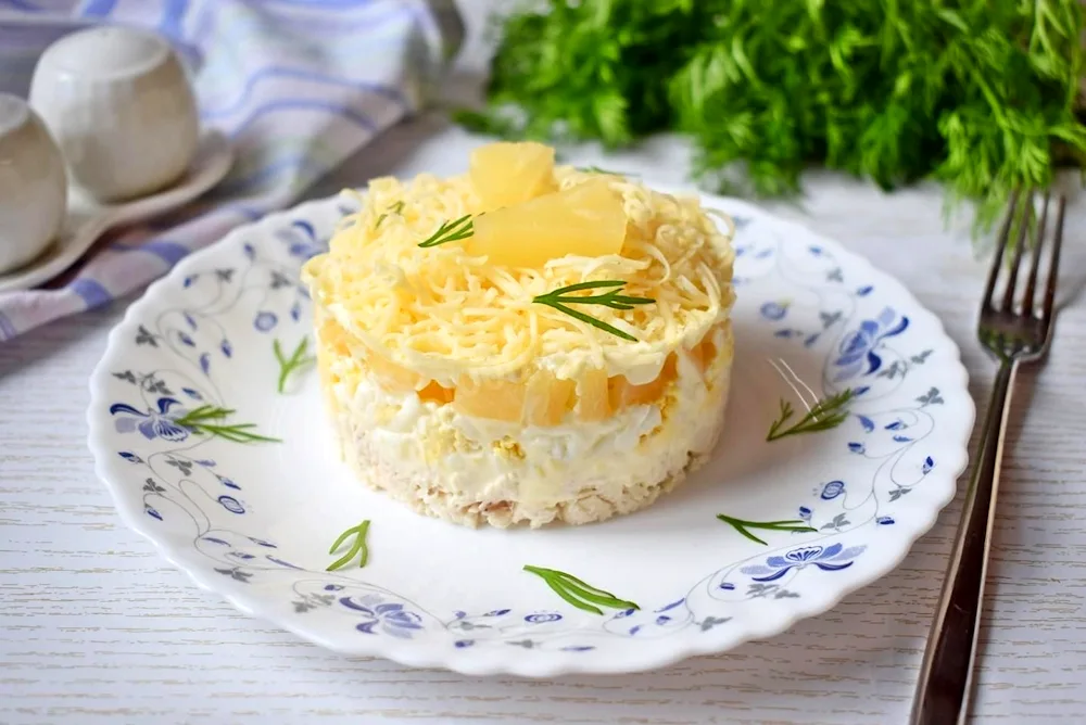 Layered salad with chicken and pineapple and cheese