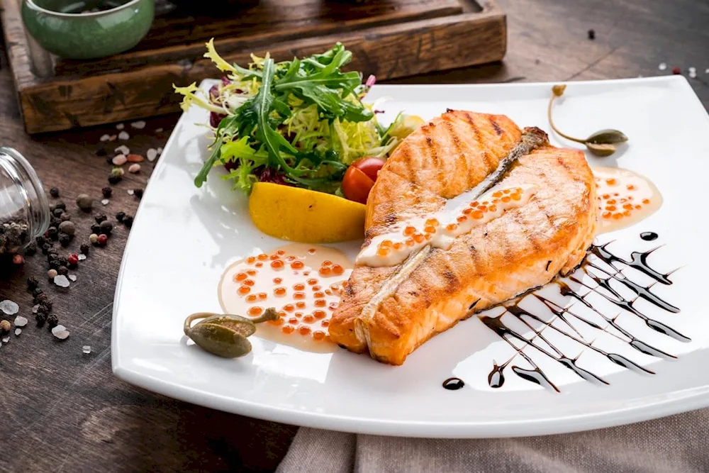 Salmon steak with caviar sauce.
