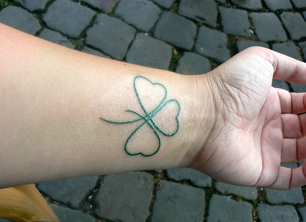 Celtic four-leaf clover tattoo