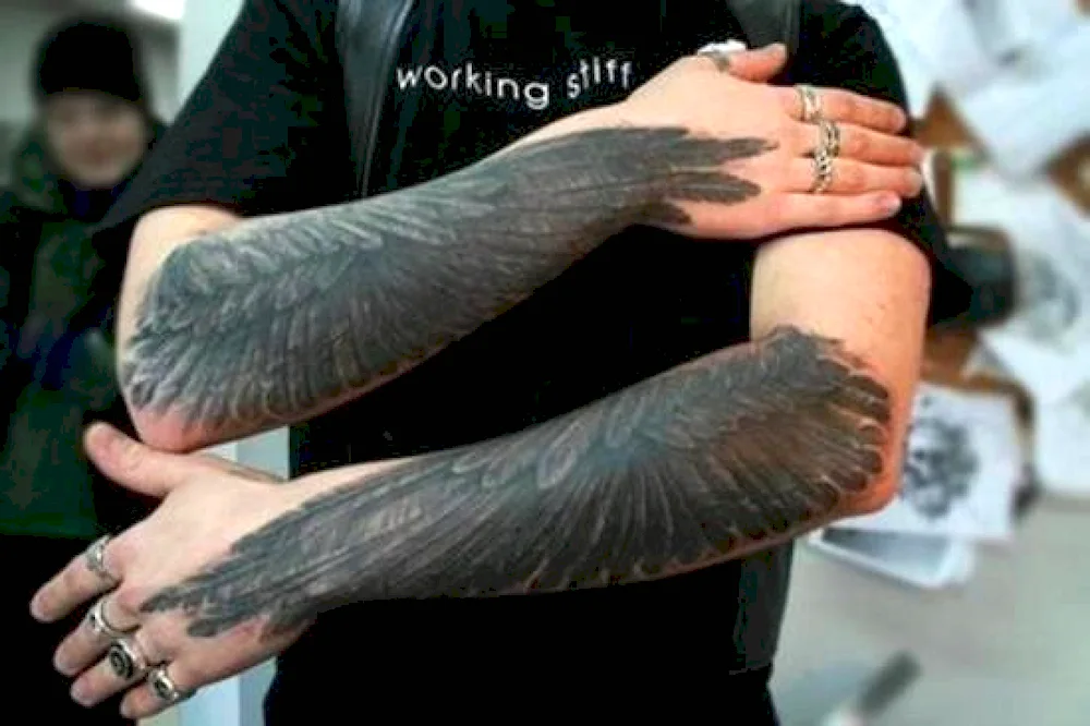 Wing tattoo on arm