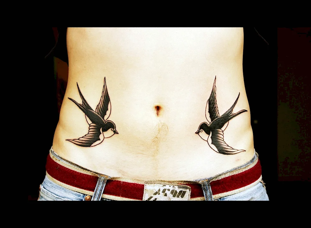 Tattoo swallows on abdomen