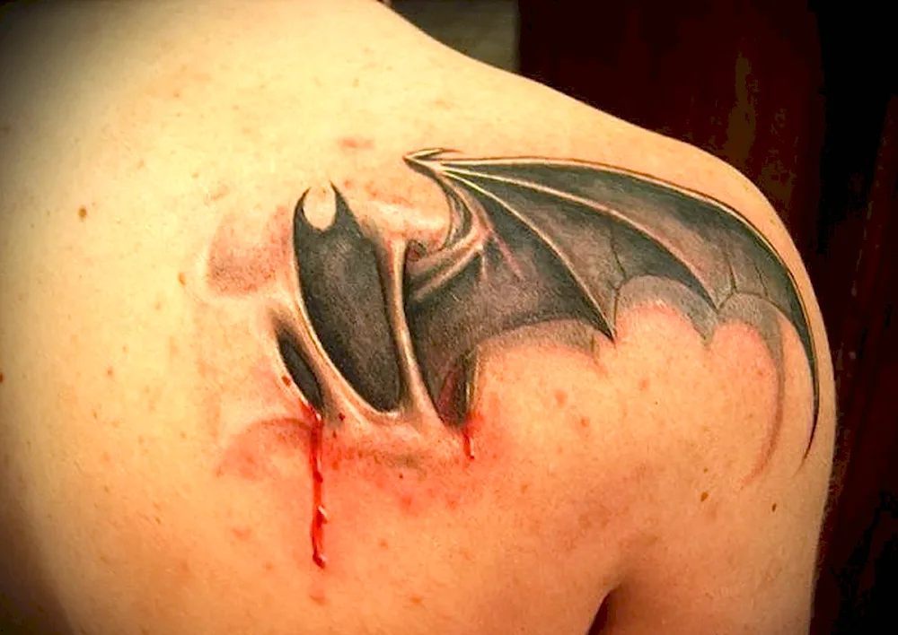 Bat Intelligence tattoo on the shoulder