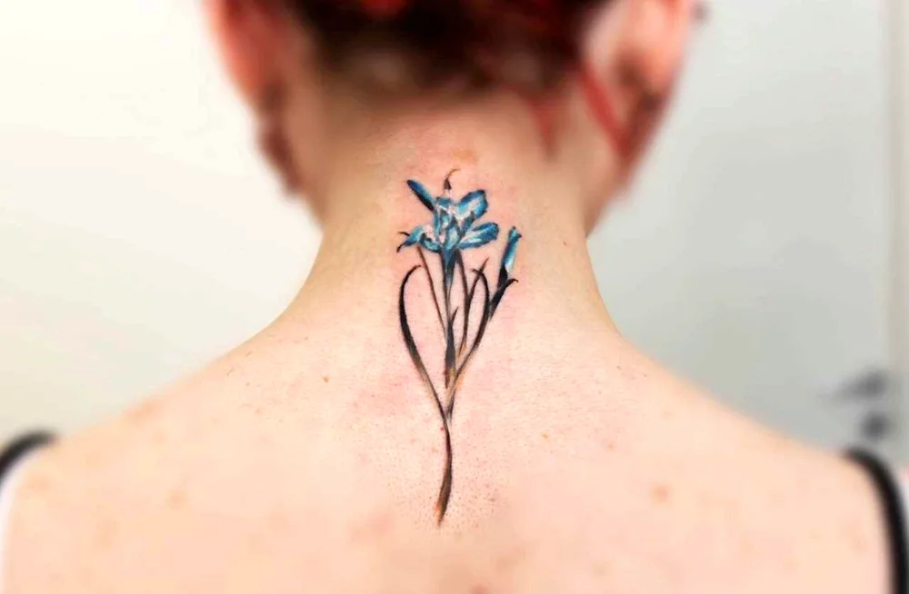 Cornflower tattoo on the neck for girls