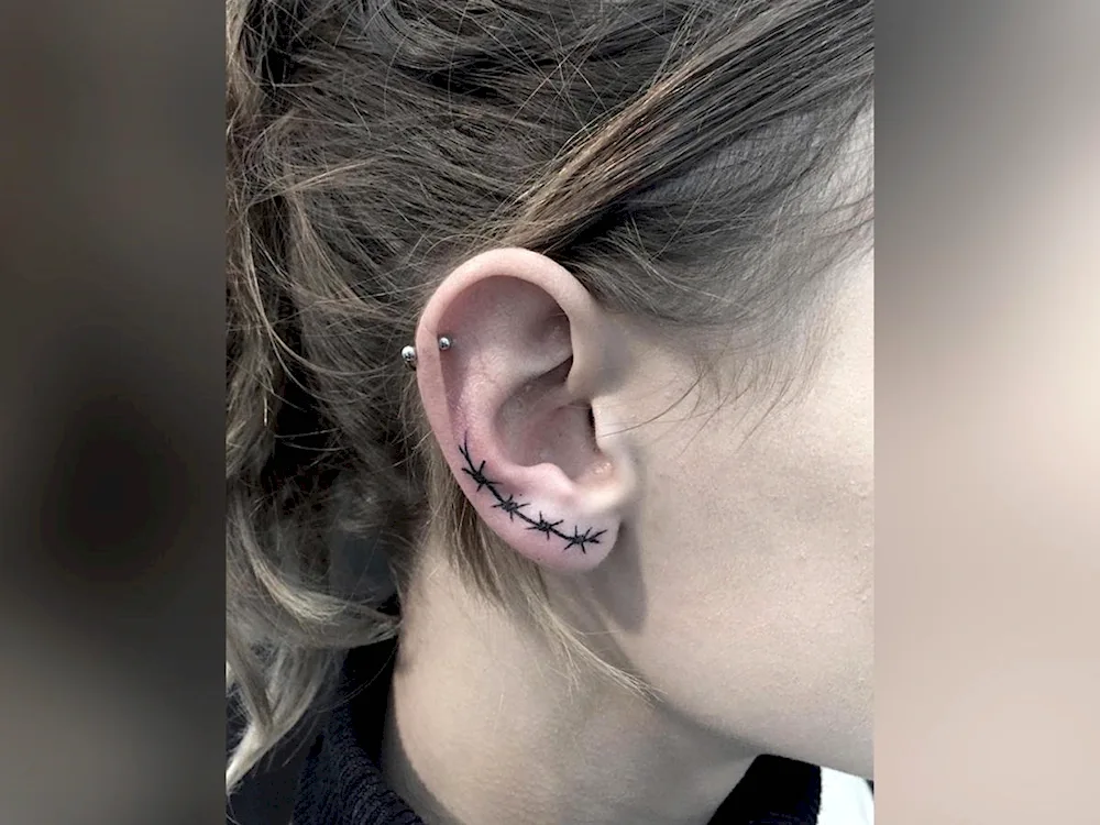 Girl ear tattoo