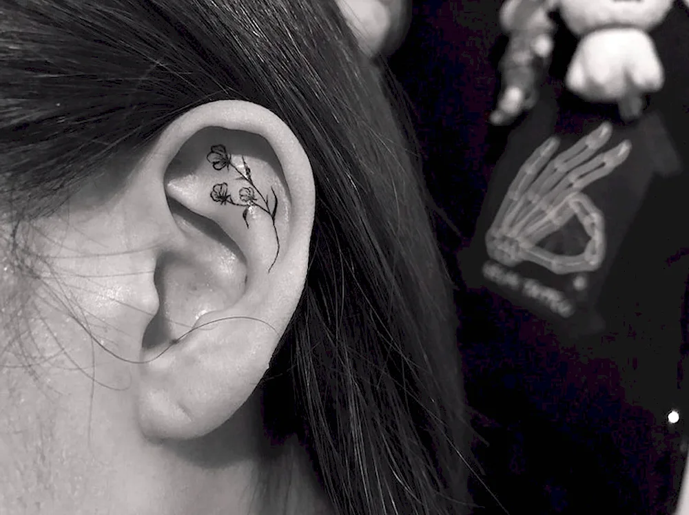 Girl ear tattoo