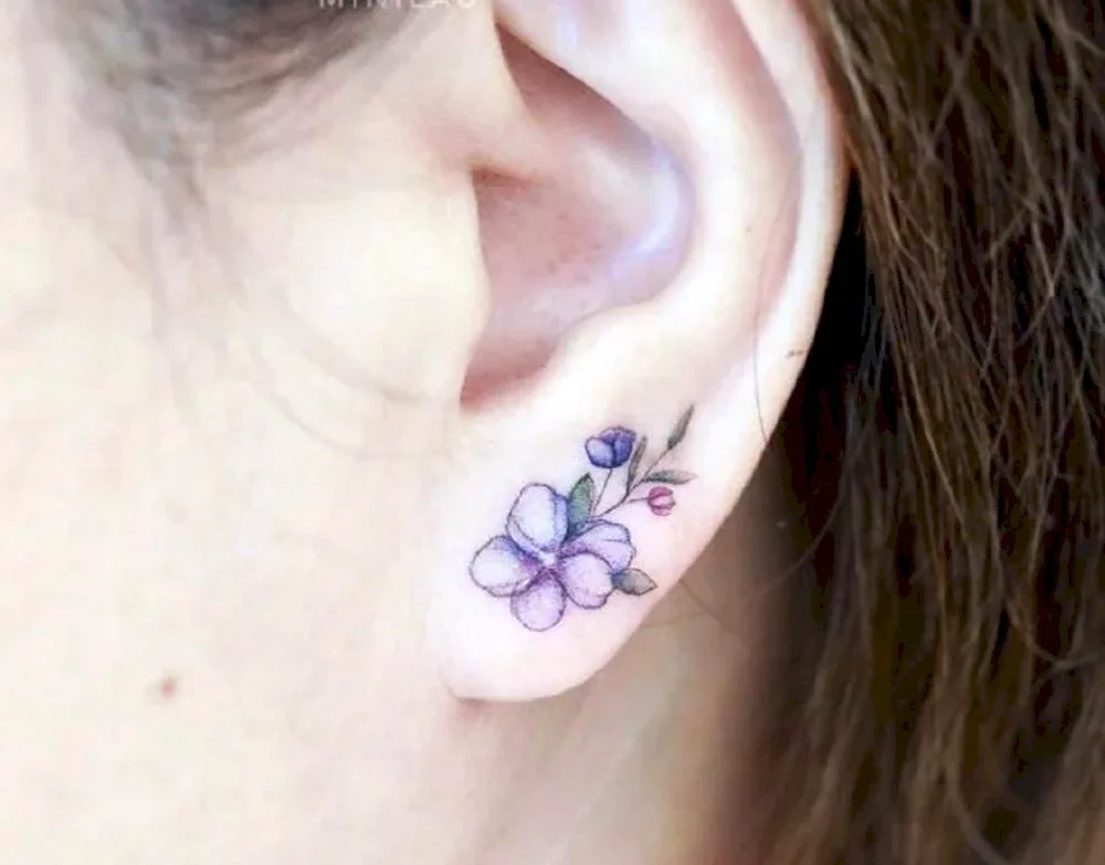 Girl ear tattoo