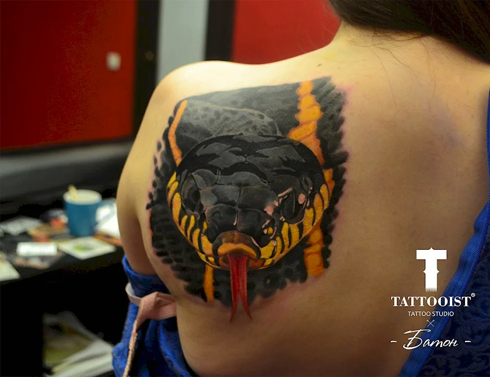 Snake tattoo on shoulder blade