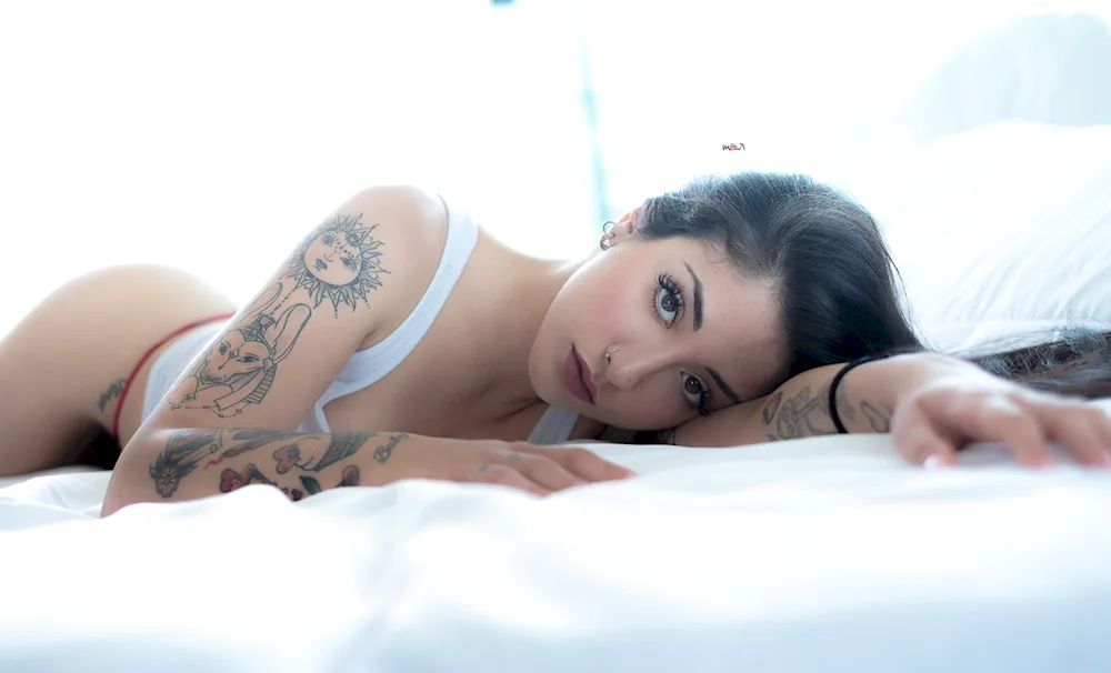 Tattooed girls in bed