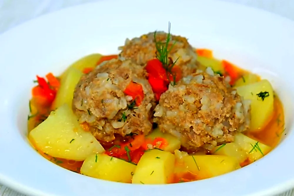 Meatballs with rice with gravy.
