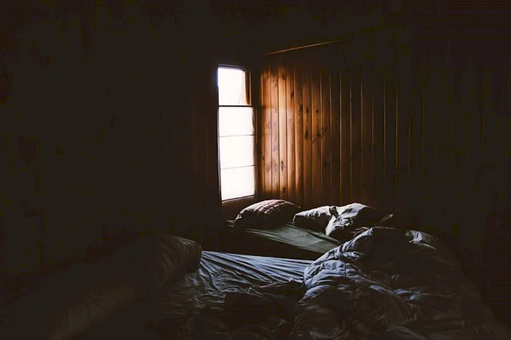 Dark room with a bed in the dark