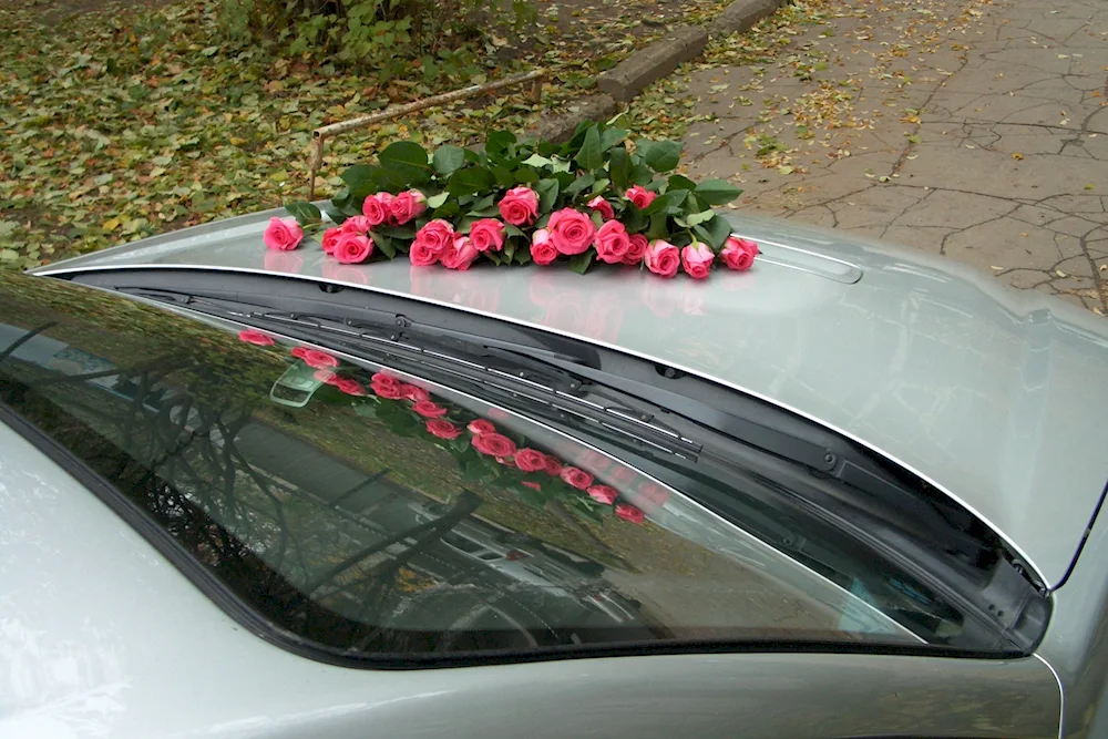 A beautiful bouquet of flowers on the bonnet of the car