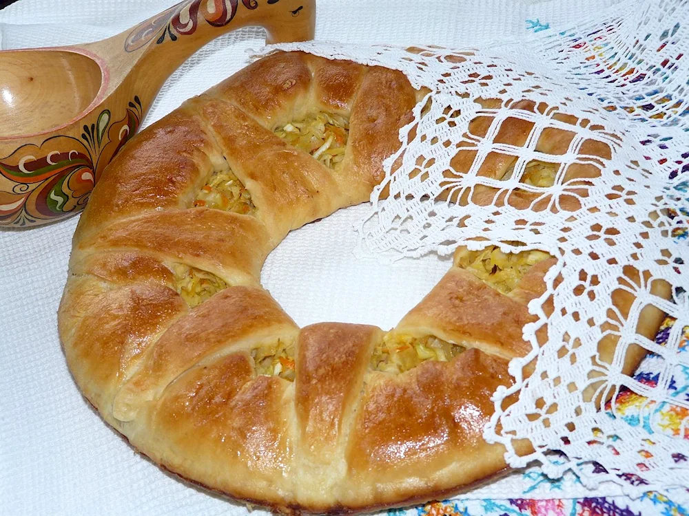 Decorations of yeast dough pies with cabbage