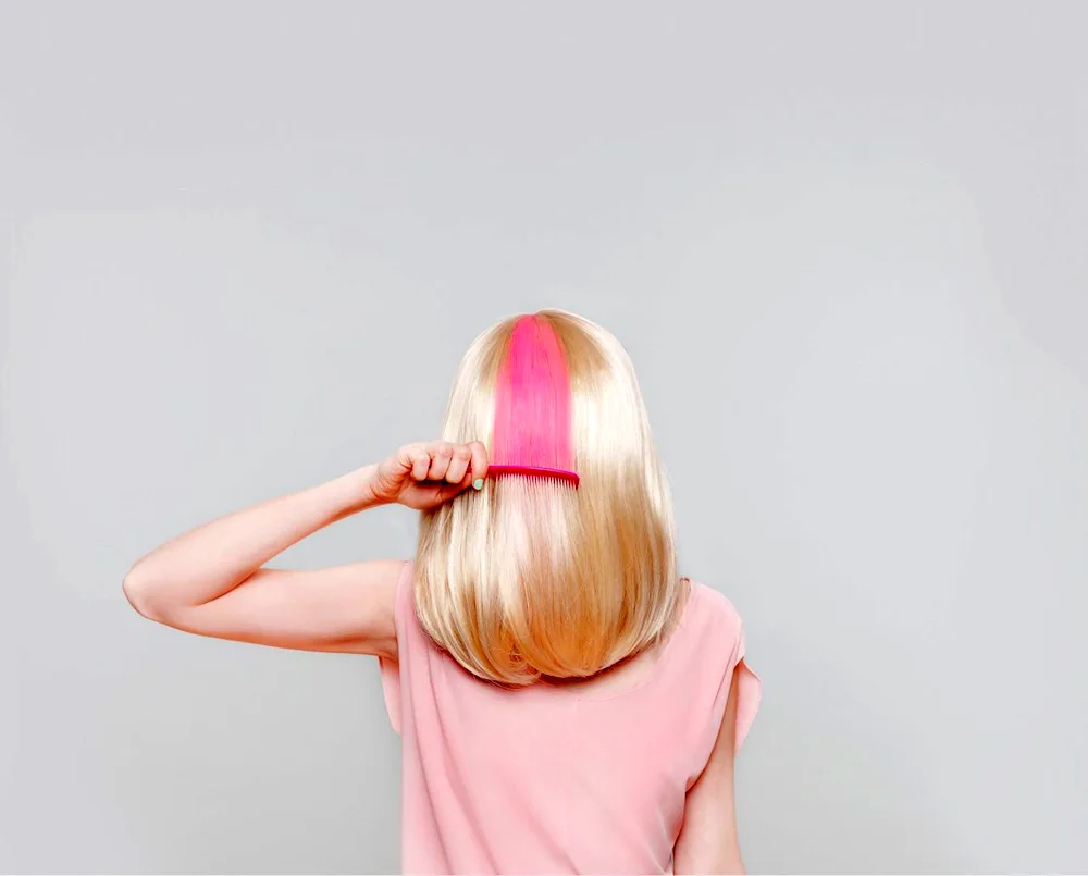 Pink strands on blonde hair