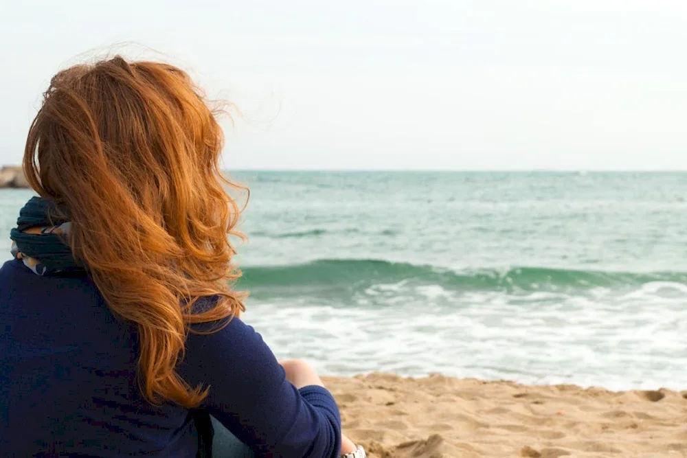 Girl with red hair from the back backs