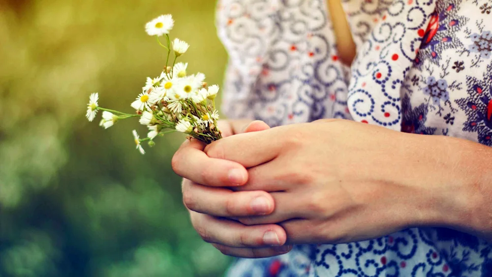 Flower on her hand.